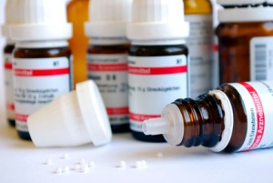 closeup of homeopathic globul with bottles in background